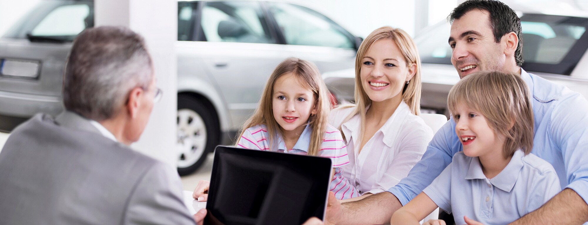 Family meets with man at dealership