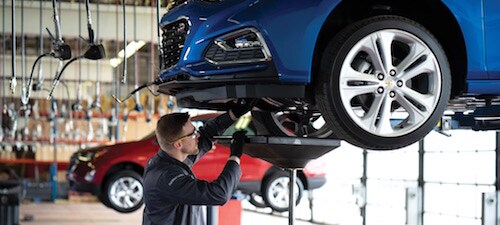 Kriegers Collision Center A service tecnician working under a car