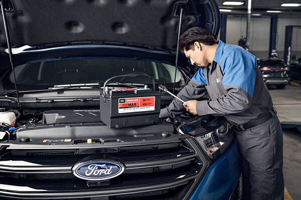 Kriegers Collision Center Service technicians fixing a battery