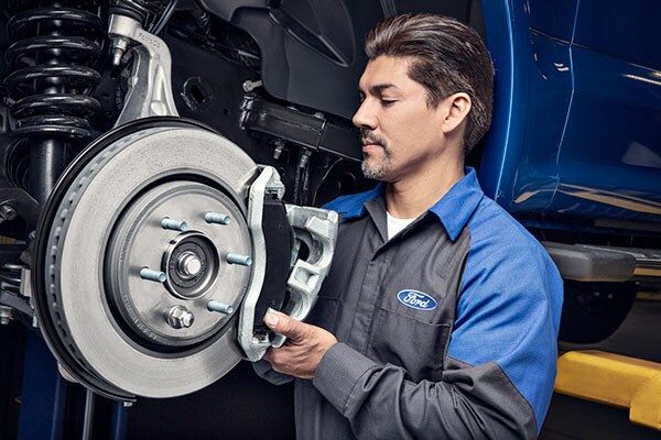 Kriegers Collision Center A service tecnician rotating a tire