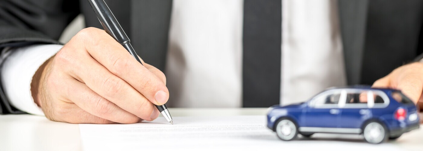 Man signing paperwork