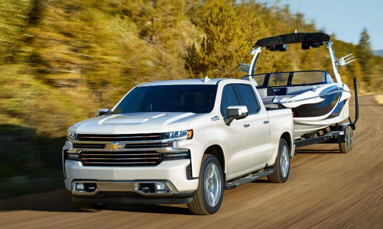 2021 Chevy Silverado 1500 in white exterior towing a boat