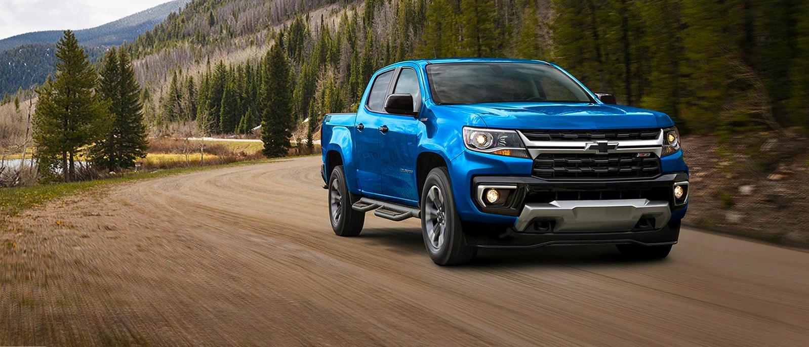 2021 Chevy Colorado truck in blue exterior driving on mountain range
