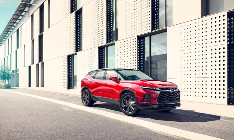 2023 Chevrolet Blazer parked by a large modern building