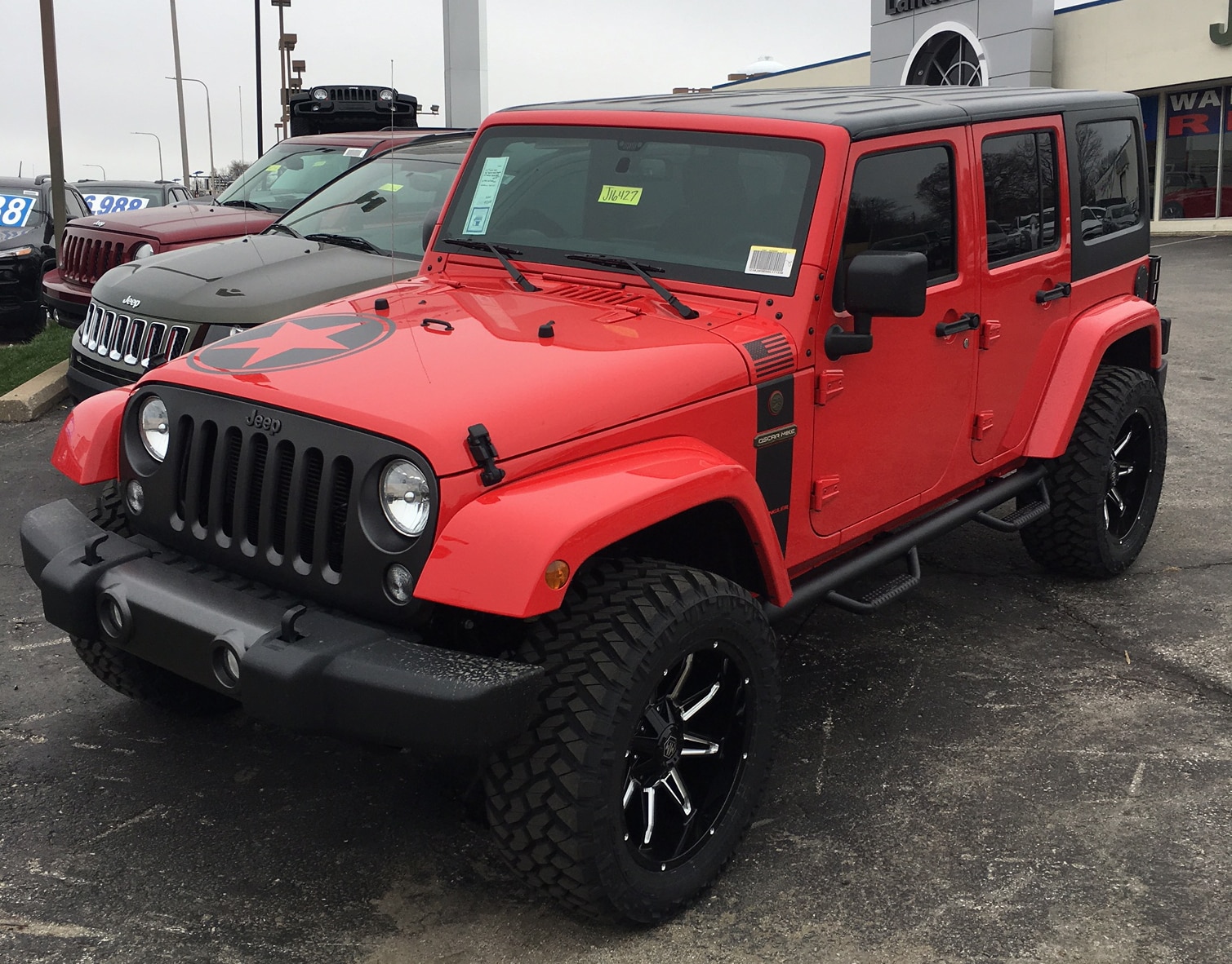 LAND_Mer2.jpeg red four door jeep at Landmark CDJR