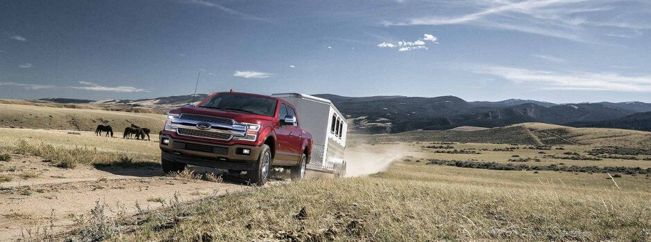 2018 Ford F-150 Schedule a Test Drive 2018 Ford F-150 pulling a trailer through the countryside