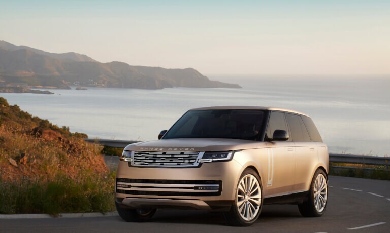 2025 Land Rover Range Rover in gold at waterfront