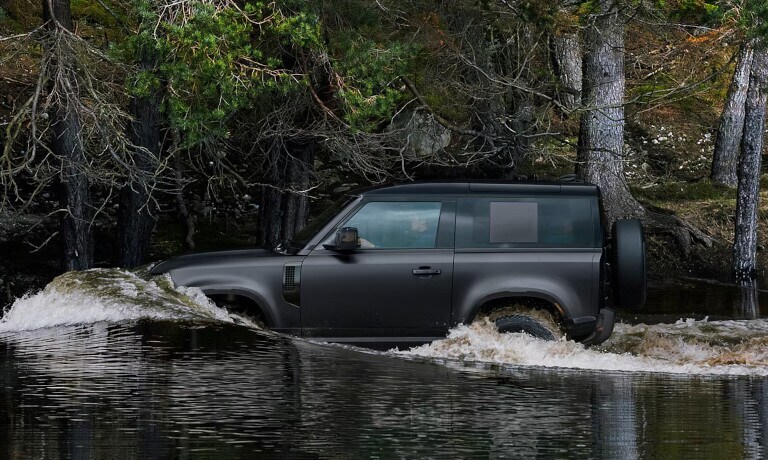 2026 Land Rover Defender driving in a stream