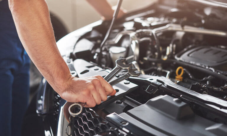 Mechanic working under the hood of a car