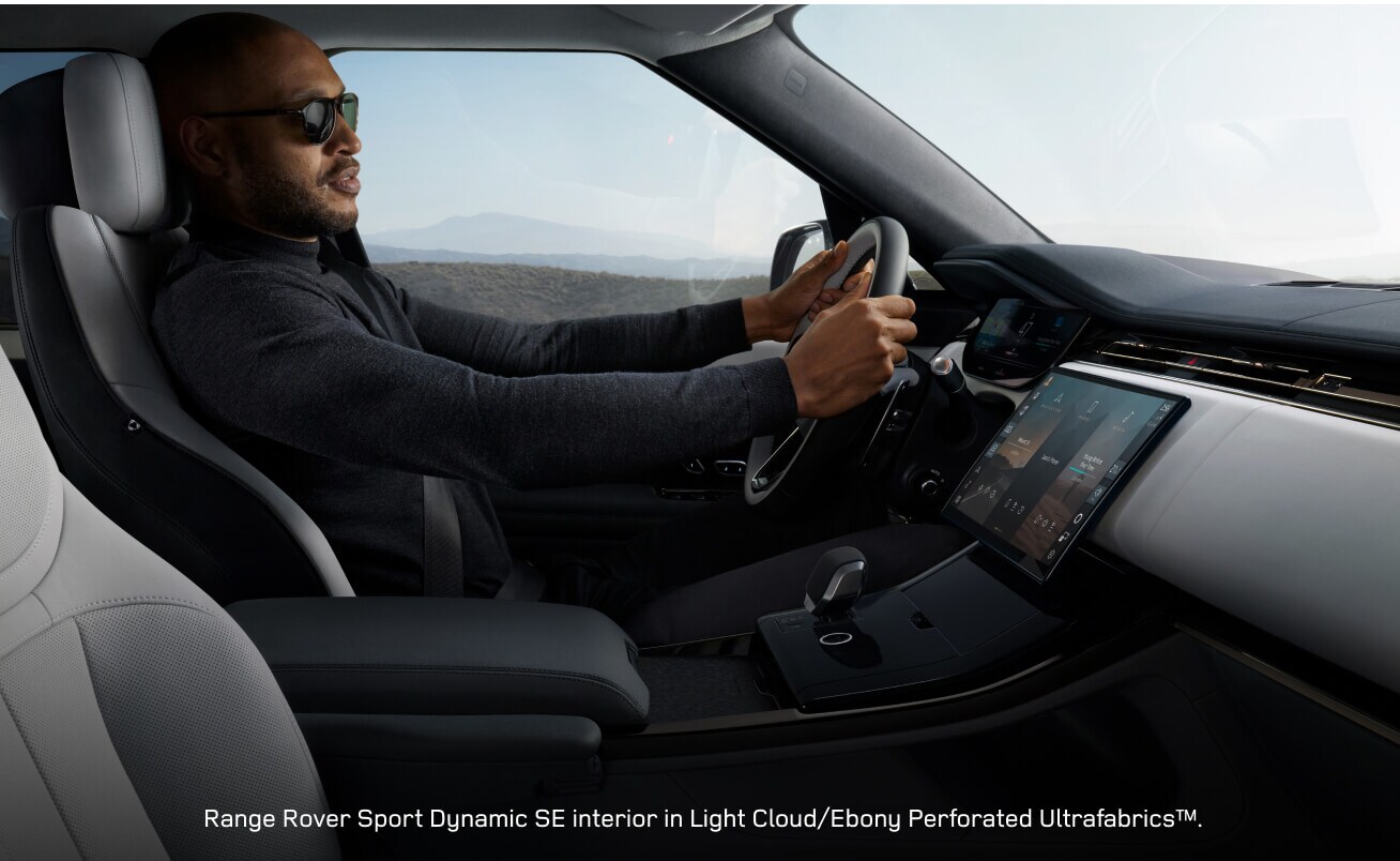 Interior profile view of a Range Rover Sport Dynamic SE featuring a driver steering.