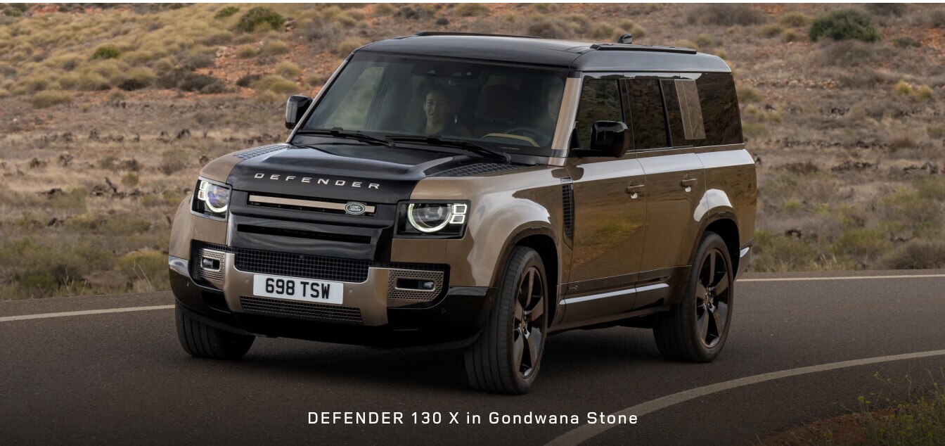 Front three-quarter view of a Land Rover Defender 130 X SUV in Gondwana Stone.