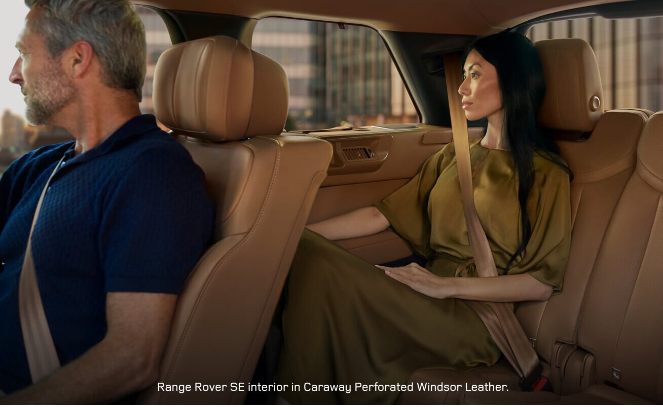 Side interior view of a Range Rover SE with Caraway seats accommodating rear passengers.
