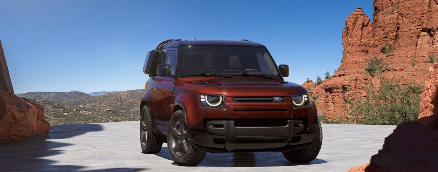 2026%20Land%20Rover%20Defender%2090%20-%20Canyon.png Red 2026 Land Rover Defender 90 parked in front of canyons