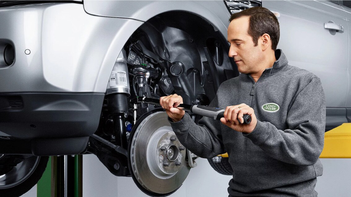 With Land Rover Express Service, you can get essential vehicle maintenance service without an appointment! A Land Rover Technician servicing a Land Rover.
