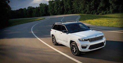Jeep Grand Cherokee L white Jeep Grand Cherokee L on winding road
