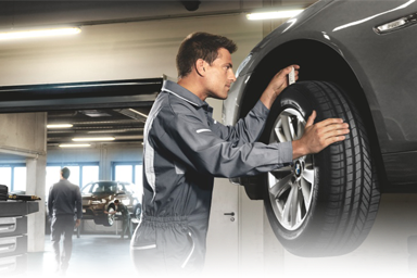 BMW Wheel Alignment BMW technician performing a wheel alignment