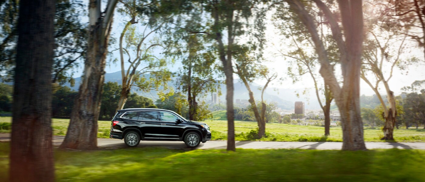 2021 Honda Pilot Exterior driving along forest trees