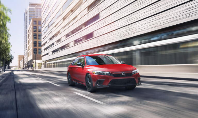 2023 Honda Civic driving fast through a popular city