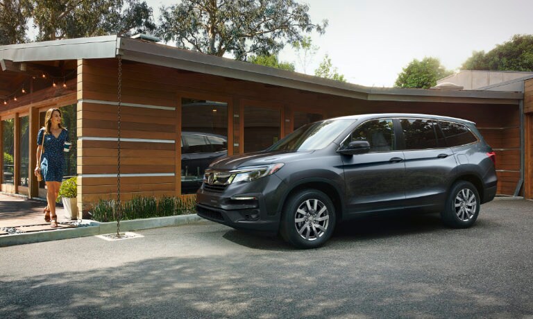 2022 Honda Pilot exterior house with family standing by