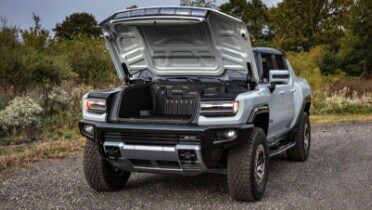 gray_gmc_hummer_open_front_trunk_on_dirt_road.jpeg