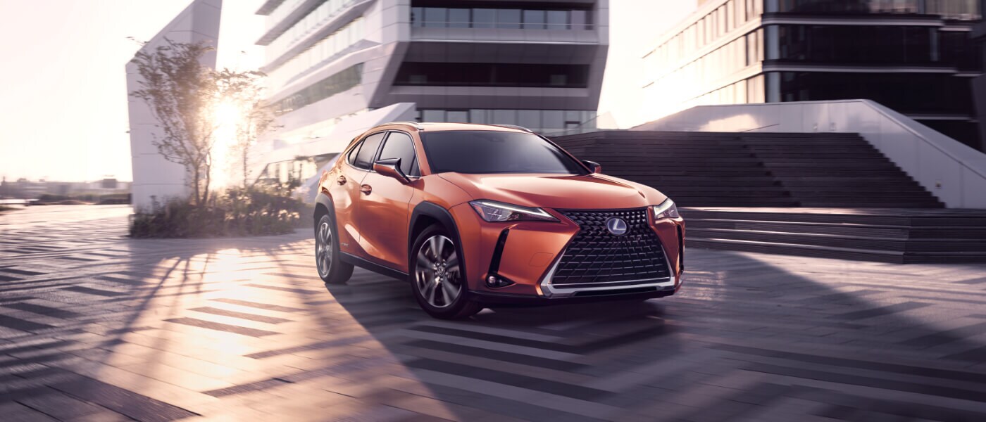 Orange 2020 Lexus UX 250h parked outside an office building