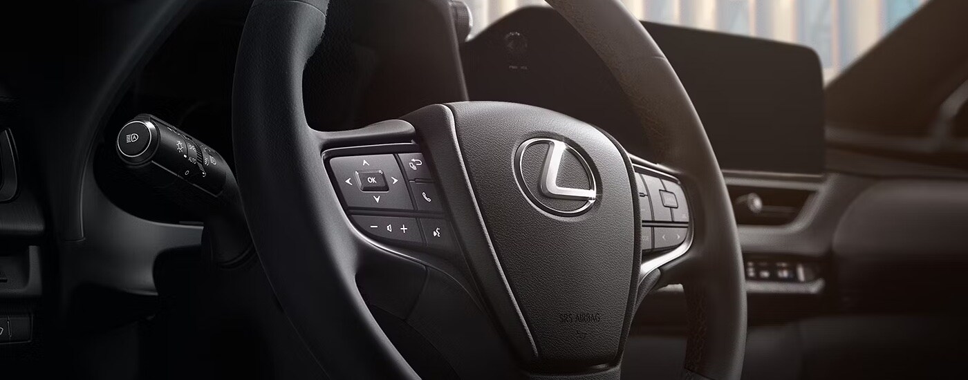 Close-up of the steering wheel in a 2025 Lexus US Hybrid for sale.