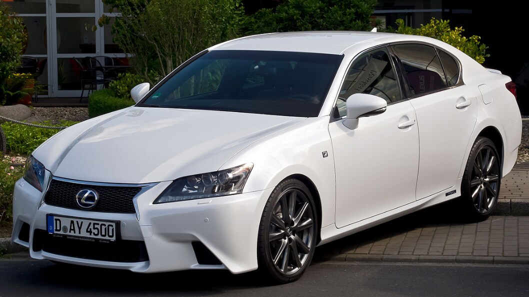 white lexus parked in front of a dealership.PNG