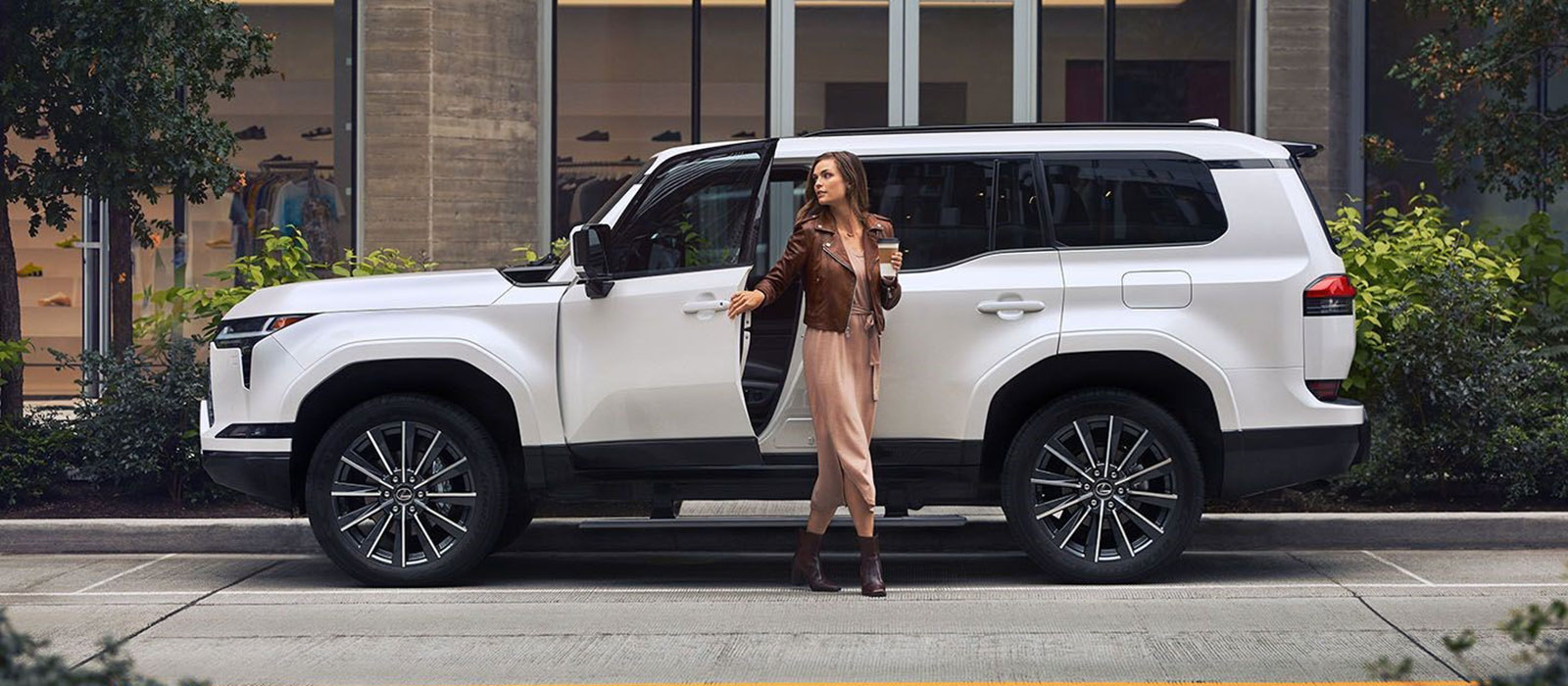 2025 Lexus GX Trim Comparison Stylish woman stepping out of a 2025 Lexus GX
