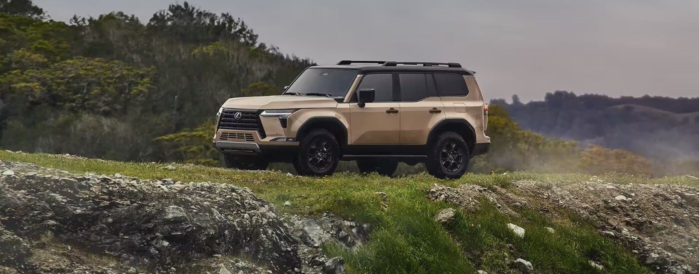2024%20Lexus%20GX%20-%20Side.jpg Beige 2026 Lexus GX parked at an angle off-road