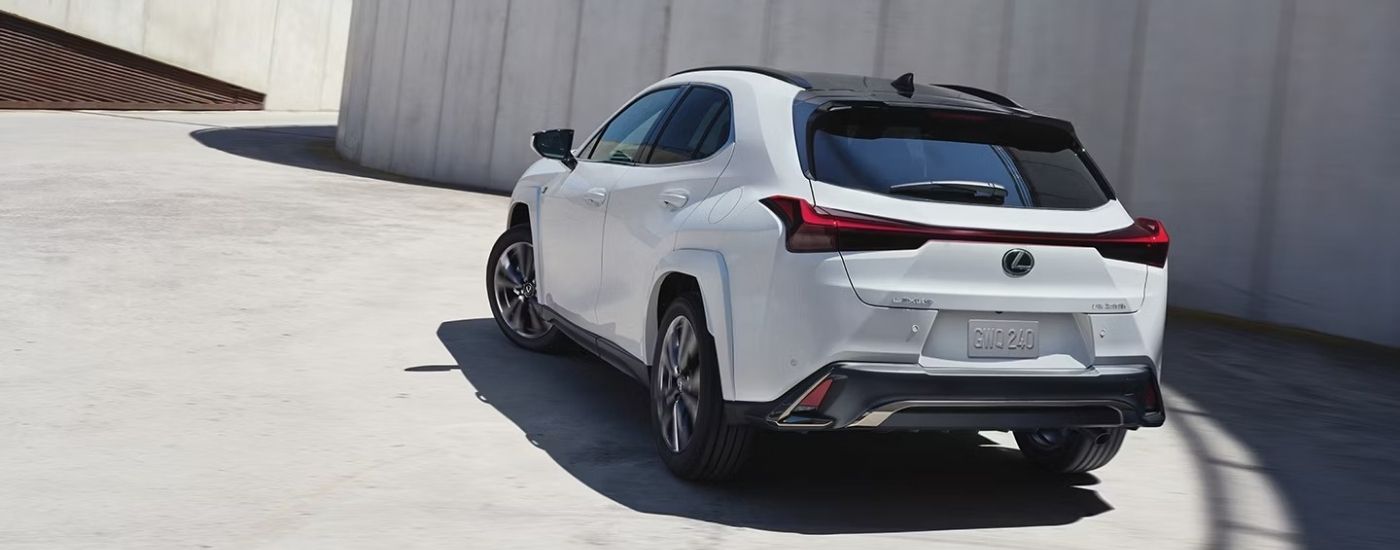 A white 2025 Lexus UXH from behind.