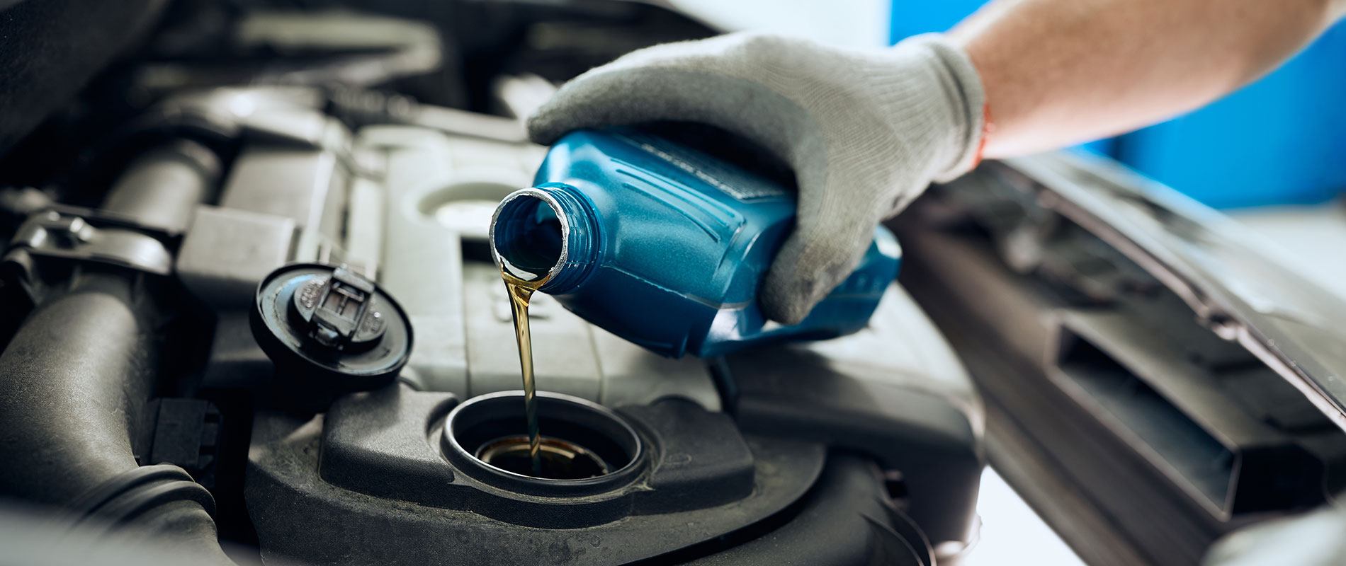 Why Service with Lexus of Peoria? Technician pours oil into a Lexus engine
