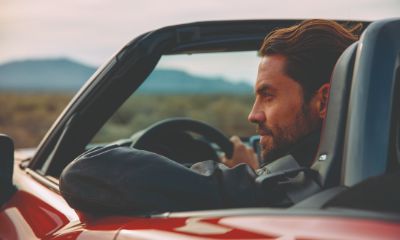 Fiat 124 Spider close up of man driving a red Fiat 124 Spider