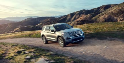 Ford Explorer silver Ford Explorer driving up a mountain