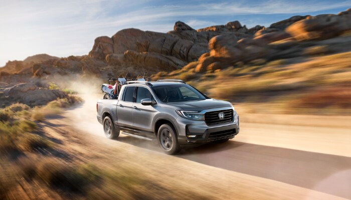 Honda Ridgeline Honda Ridgeline driving on a dirt road
