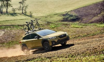 Subaru Crosstrek Yellow Subaru Crosstrek driving up a hill off-road