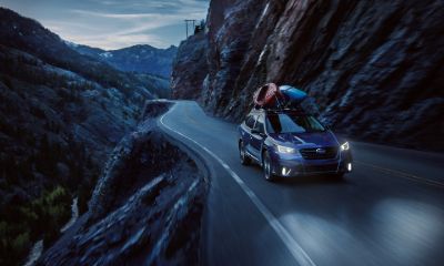 Subaru Outback Subaru Outback driving on a mountain road at night