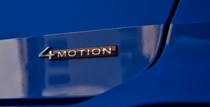 VW Taos closeup of 4MOTION all wheel drive badging on a blue VW Taos