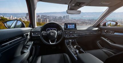 Honda Civic interior interior of a Honda Civic showing front seats and dashboard looking out onto a city