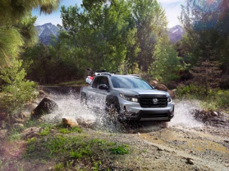 Honda Ridgeline Honda Ridgeline driving on a dirt road