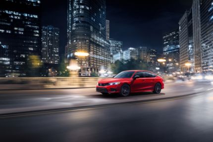 Honda red Honda driving in a city