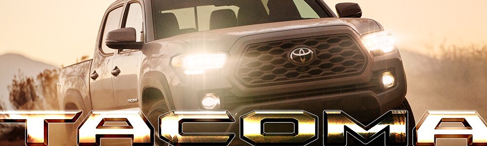 2019 Toyota Tacoma to Buy or Lease in Spokane Front view silhouette of a silver 2019 Toyota Tacoma with headlights on