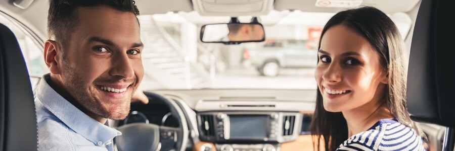 Couple in new car banner DealerInspire FullThrottle.jpg