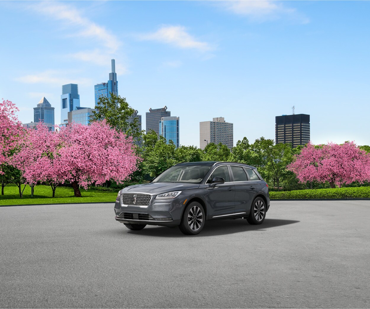 Lincoln of New Bern is a Car Dealership in New Bern near River Bend, NC | Grey 2020 Lincoln Corsair parked with spring foliage in the background
