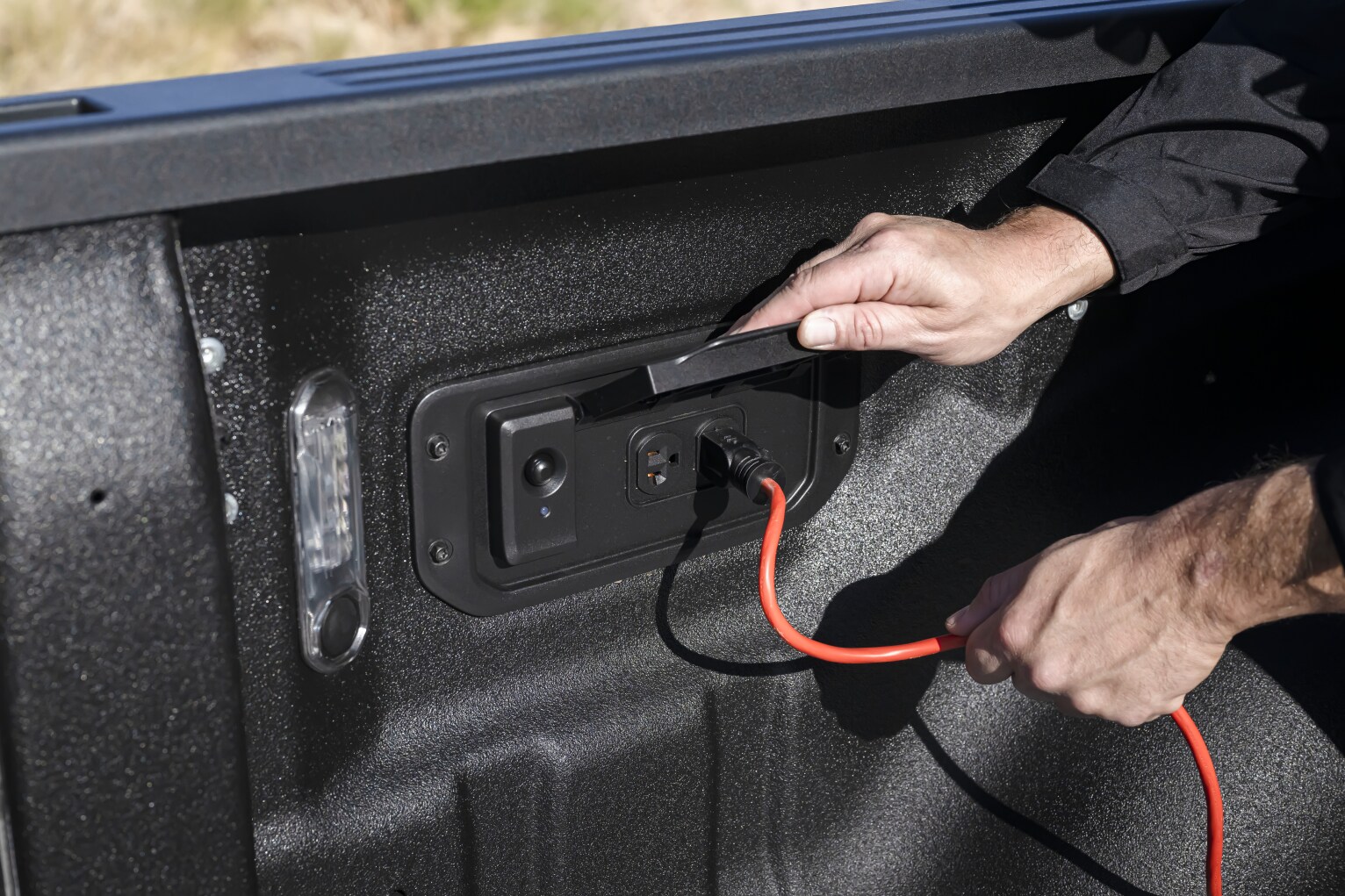 2025_Ram 1500_DT_Tungsten_LIPMAN_JL17236.png Ram 1500 RamCharger truck bed charging port