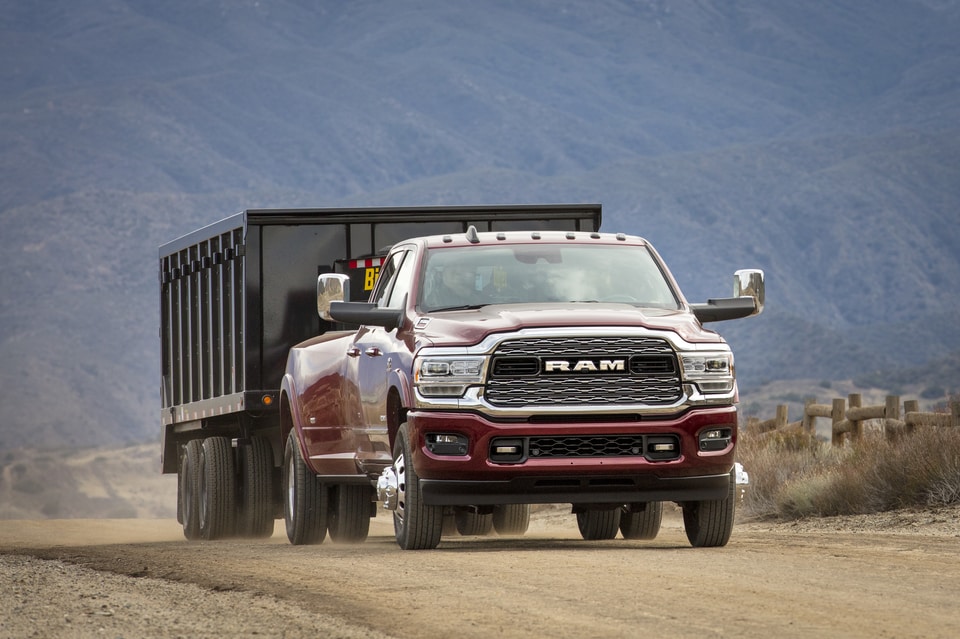 2021-RAM-3500-Limited-CrewCab-Truck-L14.png dark
red Ram 3500 Limited truck towing a dump trailer