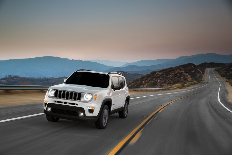 2020-Jeep-Renegade-Limited-SUV-L03.png white Jeep Renegade Limited SUV driving down the highway