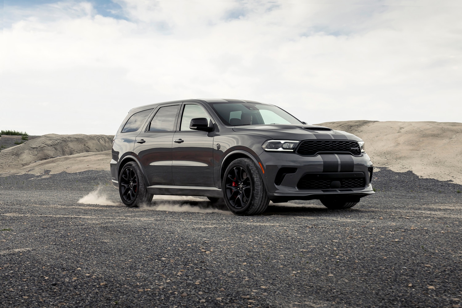 2021-Dodge-Durango-SRTHellcat-SUV-L05.png dark grey Dodge Durango turning on a gravel road