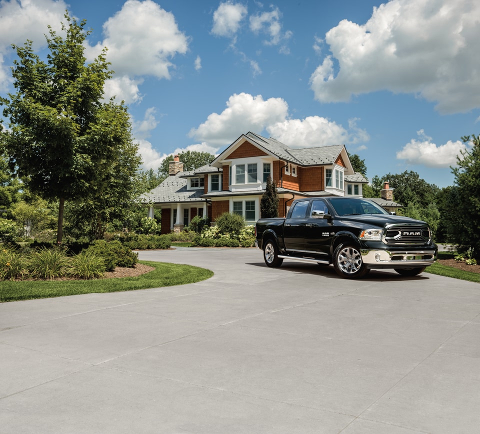2017 Ram 1500 Crew.png black Ram 1500 truck leaving a new home construction site