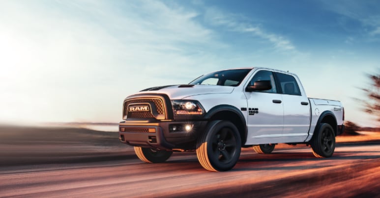New 2022 Ram 1500 for Sale.PNG white Ram 1500 truck driving fast on blurred red sand