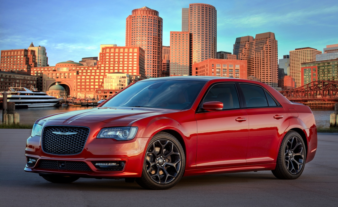 2022-Chrysler-300-S-Sedan-L03.png red Chrysler 300 sedan parked in front of a downtown area